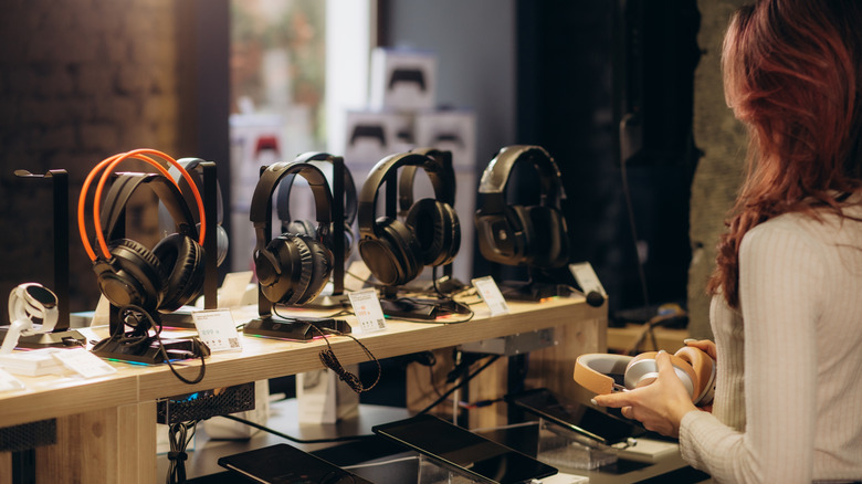 매장에서 헤드폰을 구매하는 여성