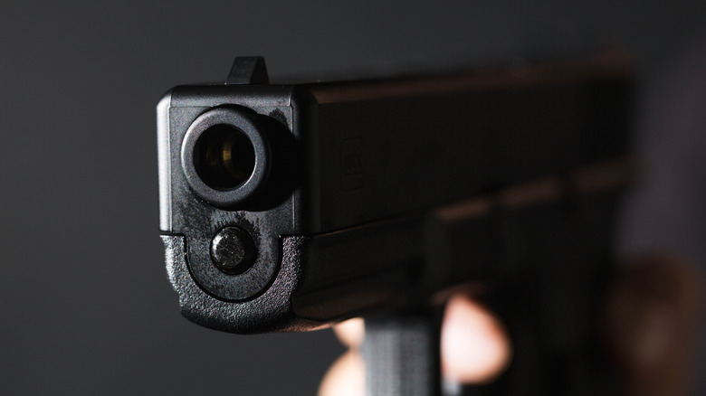 어두운 배경에 권총 배럴의 근접 촬영