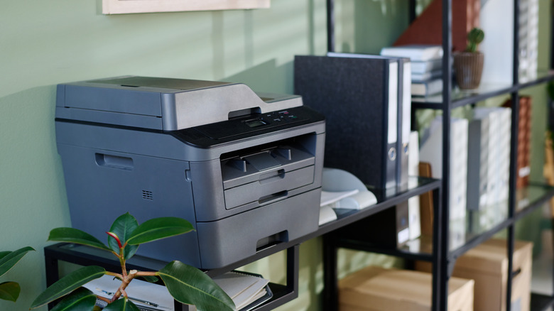 등받이가 벽을 향한 테이블 위의 프린터