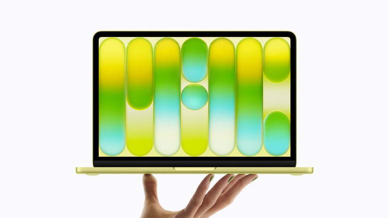 MacBook Neo를 들고 있는 손