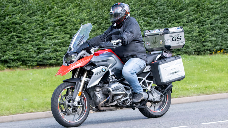 BMW R1200 GS를 타고 도로를 달리는 사람.
