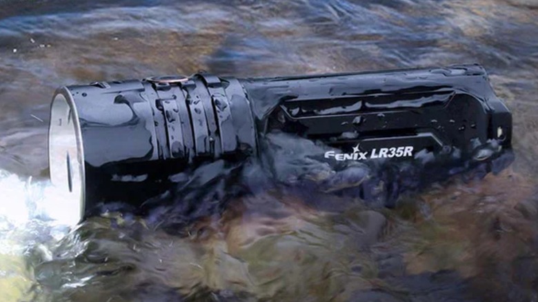 흐르는 물에 있는 Fenix ​​LR35R 손전등.