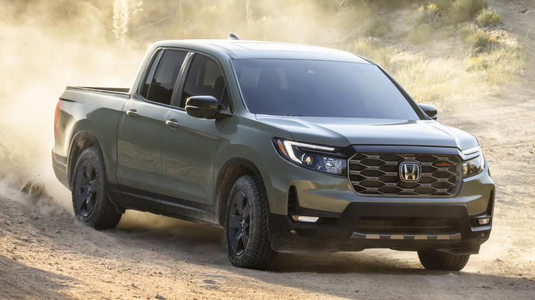 먼지가 많은 흙길을 주행하는 녹색 2026 Honda Ridgeline